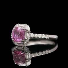 This stunning ring features a natural pink sapphire center stone with a weight of 1.57 carats, surrounded by 18 baguette, marquise, and round cut diamonds with a total weight of 0.45 carats. The center stone has a GIA certificate with the number 5234327592. The ring has a finger size of 6.75 and a gross weight of 3.20 grams. The diamonds have a clarity of VS1-VS2 and a color of F-G. Perfect for any woman who loves classic style jewelry. Vendor SKU: SR2623. Luxury Gia Certified Pink Sapphire Diamond Ring, Luxury Pink Ruby Ring In Platinum, Gia Certified Pink Diamond Ruby Ring, Gia Certified Fine Jewelry Pink Sapphire Diamond Ring, Gia Certified Pink Sapphire Diamond Ring In Fine Jewelry, Fine Jewelry Gia Certified Pink Sapphire Diamond Ring, Gia Certified Pink Sapphire Diamond Ring, Gia Certified Pink Platinum Rings, Gia Certified Pink Sapphire Ring In Platinum