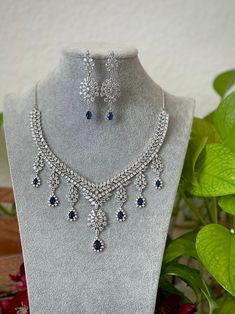 Extremely Gorgeous and Pretty White gold Plated CZ necklace with matching earrings is an elegant set for your local gatherings or parties! Measurements of the earrings: -------------------------------- Height of the earrings: 6.5 cm Width: 2 cm Care Instruction : Avoid Heat & Chemicals Like Perfume, Deo, Alchol, Etc. | Clean With Dry Cotton Cloth | Pack In our Anti tarnish box after use. White Necklace Set, Cubic Zirconia Jeweled Jewelry Sets For Celebration, Cubic Zirconia Jewels Jewelry Sets For Celebration, Cubic Zirconia Jewelry Sets For Celebration, Crystal Jewelry Sets For Celebration, Hand Set Cubic Zirconia Dangle Necklaces, Handcrafted Cubic Zirconia Dangle Necklaces, Elegant Dangle Jewelry Sets For Celebration, Formal Dangle Necklace With Elegant Design