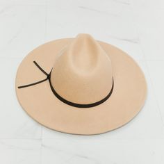 This hat is perfect for both casual and formal occasions. The soft beige color of the hat is versatile and complements a variety of outfits, while the black faux leather knot detailing adds a touch of elegance and sophistication. The adjustable straps ensure a comfortable and secure fit for any head size. The classic fedora style is timeless, and the addition of the faux leather knot detailing gives it a modern twist that sets it apart from other fedoras on the market. Fame Type: Fedora Pattern Spring Felt Hat With Adjustable Fit For Everyday Use, Spring Everyday Adjustable Felt Hat, Chic Adjustable Brown Fedora, Chic Adjustable Hat Bands, Chic Adjustable Fedora With Short Brim, Chic Fedora With Adjustable Fit And Short Brim, Chic Beige Wide Brim Fedora, Chic Adjustable Felt Hat With Short Brim, Wide Brim Hat With Adjustable Strap For Spring