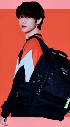 a young man wearing an orange shirt and black backpack