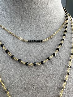 This is simple, beautiful necklace is comprised of 3mm Faceted Black Spinel hand-wrapped into a rosary style chain. Finished off with dangle of gold beads. Necklace length 16" with a 2" extender. Rosary chain is vermeil. All other components are gold filled. Gold Wire-wrapped Dangle Beaded Necklaces, Gold Wire Wrapped Dangle Beaded Necklaces, Black Beaded Lariat Necklace Gift, Adjustable Double Strand Beaded Chain Necklace, Adjustable Beaded Necklaces For Layering, Adjustable Double Strand Layered Necklace With Beaded Chain, Adjustable Double Strand Beaded Chain Layered Necklace, Layering Lariat Jewelry With Beaded Chain, Double Strand Beaded Chain Necklace For Layering