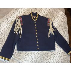 Amazing Condition. This Striking Double D Ranch Wear Jacket Is A Beautiful Addition To Any Wardrobe. The Military-Style Jacket Features A Solid Blue Wool Outer Shell With Knit Fabric Type And Suede Fringe Accents. The Jacket Is Adorned With Intricate Beaded And Embroidered Designs, Adding An Extra Touch Of Sophistication To The Piece. The Jacket Has A Button Closure, Long Sleeves, And A Collared Neckline, Making It Suitable For Various Occasions Such As Travel, Parties, Or Casual Outings. The Ja Luxury Vintage Denim Jacket With Double-needle Stitching, Military Double-breasted Outerwear With Pockets, Vintage Embroidered Blue Outerwear, Blue Embroidered Button-up Outerwear, Vintage Military Outerwear With Buttons, Double D Ranch, Ranch Wear, Embroidered Designs, Western Jacket