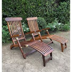 three wooden lawn chairs sitting next to each other in front of some bushes and shrubbery