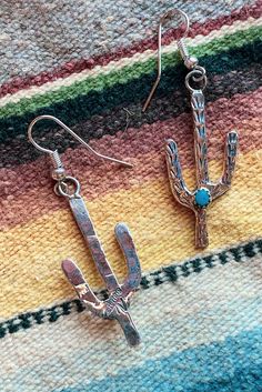 Sterling Silver and Turquoise Saguaro Cactus Earrings Native American Made Genuine Turquoise stones. Stone color and matrix may vary due to their natural characteristics. Cactus stamped sterling. Ear wires are silver plated. Cactus measures 1 1/4" long not including the french hook. 3 mm stones Western Style Turquoise Dangle Jewelry, Western Style Dangle Earrings For Pierced Ears, Southwestern Nickel-free Jewelry As Gift, Nickel-free Southwestern Style Jewelry As Gift, Nickel Free Southwestern Jewelry For Gift, Nickel-free Southwestern Style Jewelry For Gift, Nickel-free Southwestern Jewelry For Gift, Nickel-free Western Style Earrings, Nickel-free Adjustable Western Earrings