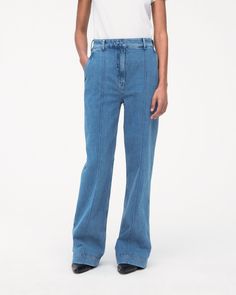 High-waisted, with a straight leg fit, these pants have a slimming effect enhanced by elongating front seams extending from thigh to ankle. A double hook and bar closure with an interior button provide a clean finish in the front, while the back is fit to provide lift and shape.Our denim is made from organic cotton processed in a GOTS-Certified Italian mill. We’ve invested in working with a responsible denim mill that measures their impact and uses data to push the industry forward. They’ve deve Medium Wash Flare Jeans With Seam Detailing, Spring Medium Wash Flare Jeans With Seam Detailing, Medium Wash Cotton Bottoms With Seam Detailing, Mid-rise Blue Flare Jeans With Contrast Stitching, Cotton Bottoms With Medium Wash And Seam Detailing, Blue Mid-rise Flare Jeans With Contrast Stitching, Denim Blue Flare Jeans With Seam Detailing, Mid-rise Medium Wash Pants With Contrast Stitching, High Waist Medium Wash Jeans With Seam Detailing