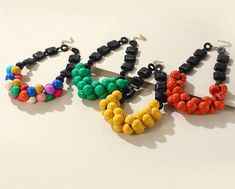 Multicolor Wooden Beads Necklaces For Party, Multicolor Party Necklaces With Wooden Beads, Multicolor Wooden Beads Jewelry For Party, Multicolor Beaded Plastic Necklace, Multicolor Wooden Beaded Necklaces For Party, Multicolor Wooden Beads Necklace For Party, Plastic Round Beads Necklace For Gift, Casual Multicolor Jewelry With Black Beads, Plastic Beaded Necklace With Round Beads