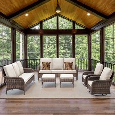 a covered porch with wicker furniture and wood flooring is featured in this image