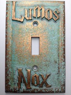 a light switch cover with the words lumos and nox written in gold on it