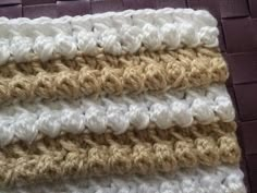 the crocheted blanket is made up of two different colors, one white and one brown