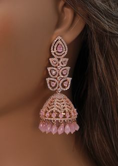 A premium quality statement CZ long jhumki earrings with Monalisa Stone and Beads tassels. Add a pop of color with this trendy long Jhumki for a touch of sparkle in your festive looks. Length: Approx. 3" Weight of each earring: 21 gms Push-Back closure Finish: Rose Gold Polish High-quality brass as the base metal. Availability: In-Stock. *Color may vary slightly due to light condition & photography. Jewelry Care: Keep away from moisture. Allow perfumes and lotion to dry before wearing. Store in