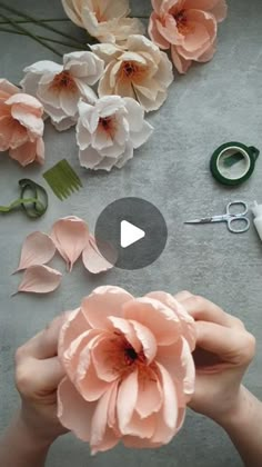 someone is making flowers out of paper and scissors