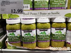 several jars of basil pest on display for sale