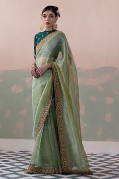 Green pure tissue silk saree with a sequin and thread hand embroidered border. Paired with a padded blouse with back tassel tie-up and petticoat. - Aza Fashions Embellished Saree, Tissue Silk Saree, Padded Blouse, Tissue Saree, Embroidered Border, Green Saree, Blouse For Women, Indian Fashion Designers, Silk Organza