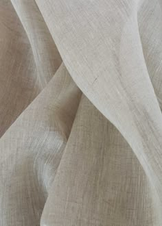 a close up shot of the fabric on a bed sheet that has been made with natural linen