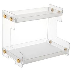 clear acrylic shelf with two gold - plated handles on the top and bottom