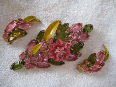 Unsigned Hattie Carnegie brooch and earrings set, featuring pink and green rhinestones with accents of green enamel leaves Hattie Carnegie, Vintage Rhinestone Jewelry, Green Enamel, Rhinestone Jewelry, Jewellery Sets, Vintage Antique Jewelry, Vintage Rhinestone, Flower Brooch, Matching Earrings