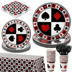 a table setting with red and black playing cards on the plates, cups, and napkins