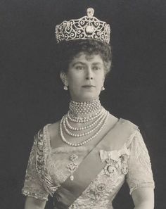 an old black and white photo of a woman wearing a tiara