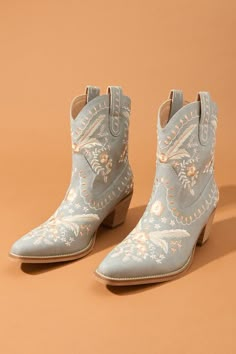 Delicate florals dance across these boots, adding a touch of unique personality and charm. The classic pointed toe and stacked heel nod to the timeless style of the Wild West. Western Boots With Floral Print For Fall, Bohemian Boots With Floral Embroidery For Fall, Bohemian Fall Boots With Floral Embroidery, Bohemian Floral Embroidered Boots For Fall, Spring Stacked Heel Snip Toe Boots, Chic Spring Mid-calf Boots With Snip Toe, Fall Floral Embroidered Snip Toe Boots, Fall Floral Embroidery Snip Toe Boots, Spring Boots With Stacked Heel And Snip Toe