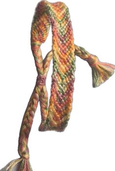 a multicolored knitted scarf hanging from a hook