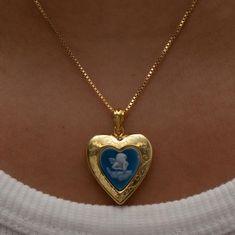 The Blue Angel Photo Locket Necklace This item is handmade to order. Please click the ‘SHIPPING’ bubble for more information on turnaround times. The locket is fully functional, with an option to include a photo! Metal: 18KT Gold Vermeil Chain type: Box Length: 16" total Locket Size: 0.75" NOTE: Please do not get your lockets wet or submerge them in water. As these items include paper goods, we will not be liable for any water damage that can ruin your photo. *Any items purchased with a discount Blue And Gold Aesthetic, Vintage Gold Necklace, Photo Locket Necklace, Blue Angel, Heart Locket Necklace, Dope Jewelry, Photo Locket, Funky Jewelry, Jewelry Lookbook