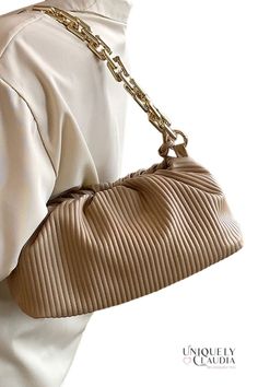 Gorgeous and unique to take your style up a notch...check out our Shaune Pleated Handbag – it's chic, sophisticated, and totally on trend. This ultra-soft vegan leather bag comes with two straps, and it is a 3-in-1...it can me worn as a clutch, under-shoulder, or crossbody. A goldtone bold chainlink, and a crossbody strap that lets you go hands-free. Plus, the pleated design is both eye-catching and elegant, and the handbag itself is spacious enough to hold all your essentials. Whether you're he Fall Shoulder Bag With Chain Strap, Trendy Large Capacity Leather Clutch, Trendy Day Out Bag With Double Handle, Chic Baguette Bag With Adjustable Strap, Trendy Double Handle Bag For Day Out, Chic Baguette Tote Bag With Adjustable Strap, Trendy Double Handle Day Out Bag, Chic Crossbody Satchel For Day Out, Trendy Faux Leather Shoulder Bag