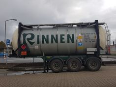 a tanker truck is parked on the side of the road