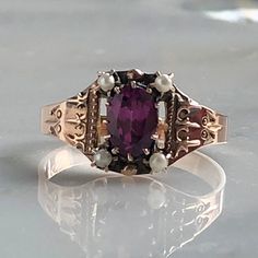 Details: Beautiful Victorian Garnet and Seed Pearl ring set in lovely 14K rose gold. The band is adorned in lovely abstract filigree engraving. The stone has great depth, and has a lovely rich pink tint to the garnet. It is surrounded by 4 seed pearls. The garnet measures 7.5mm x 5mm. There are no internal markings. Measurements: Ring measures a size 7 3/4 US. It can be re-sized for a fee. Condition: The overall all condition of this ring is very good. Please ask all questions prior to placing a Victorian Gold Ring, Garnet And Pearl, 18k Gold Engagement Ring, Seed Pearl Ring, Heart Band, Ruby Heart, Gold Heart Ring, Victorian Rings, Etsy Gold Ring