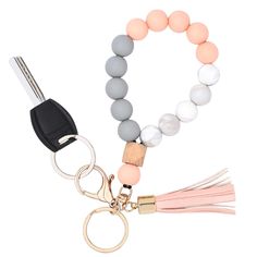 the beaded keychain with tassel is shown in grey, white and pink