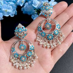 Featured is a traditional jadau chandbali earrings made on sterling silver and hand-studded with pearls and turquoises. The earrings have not been gold plating and are being presented in silver finish itself. The earrings close with a bombay screw mechanism. This classic design is crafted with precision and features a sterling silver base adorned with pearls and turquoise stones, all securely fastened with a traditional bombay screw closure. Silver Chandelier Earrings With Tilla For Gifts, White Sterling Silver Chandbali Jewelry, Silver Meenakari Chandelier Earrings, Turquoise Chandbali Jewelry With Latkans, Elegant Turquoise Meenakari Earrings, Silver Meenakari Dangle Jewelry, Sterling Silver Chandbali Earrings For Festivals, Sterling Silver Chandbali Bridal Earrings, Sterling Silver Chandbali Earrings For Gift