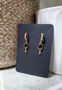 So elegant, but simple enough to be worn any day. These extremely lightweight earrings feature a beautiful emerald green glass bezel charm and a cubic zirconia paved huggie hoop. Even more beautiful in person! Total length is just over 3cm. ❤️ Handmade with love ❤️ Great for gifting Every item is handmade by me, so please understand there are no two items exactly alike. All jewelry may vary slightly from how they are pictured, but I try my best to take accurate pictures and make them all the same. Most metals will tarnish eventually, but there are things you can do to keep your jewelry looking great for as long as possible. Avoid spraying with perfumes or wearing in the shower. Storing your earrings in the plastic bag they arrive in will slow down the tarnishing process and keep them looki Elegant Small Hoop Green Earrings, Elegant Green Hoop Earrings, Elegant Green Dangle Hoop Earrings, Elegant Small Hoop Emerald Earrings, Elegant Small Hoop Emerald Jewelry, Elegant Green Emerald Hoop Earrings, Elegant Green Hoop Earrings For May Birthstone, Elegant Green Hoop Earrings As Gift, Single Green Hoop Earring