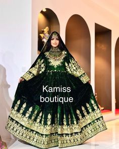 a woman in a green and gold dress with the words kalmiss boutique on it