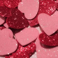 pink and red heart shaped confetti sitting on top of each other