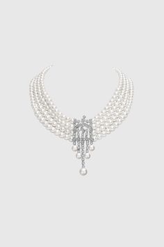 This sumptuous piece of jewelry features a retro-elegant yet slightly modern style that complements the lavish garments, reminiscent of the roaring 1920s. Features: Multi layer imitation pearls Rhinestone studded shimmering pattern Pearl strand lengths: 6.5", 6.9", 7.3", 7.9" 6-8mm pearls 1920 Accessories, Roaring 20s Jewelry, 20s Jewelry, Rose Gold Pearl Necklace, Flapper Accessories, 1920s Necklace, Multi Strand Pearl Necklace, 1920s Jewelry, Roaring 1920s