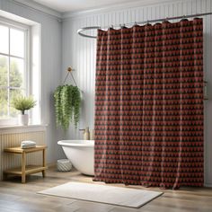 a bathroom with a bathtub, sink and shower curtain in the middle of it