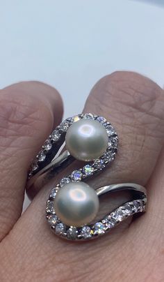 Vintage White Pearl 925 Sterling Silver Cocktail Ring Size 8 https://www.etsy.com/listing/1198215606/vintage-white-pearl-925-sterling-silver?utm_source=crowdfire&utm_medium=api&utm_campaign=api Silver Pearl Rings With Diamond Accents, Silver Rings With Diamond Accents And Pearl, Elegant Silver Pearl Ring Stamped 925, Elegant Sterling Silver Pearl Ring Stamped 925, Classic Diamond White Pearl Ring Gift, Exquisite Hallmarked Pearl Ring For Anniversary, Silver Pearl Ring With Diamond Accents, Fine Jewelry Silver Pearl Ring, Wedding Pearl Ring Stamped 925