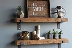 two wooden shelves with plants on them and some signs above the shelves that say home sweet home