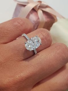 a woman's hand with a diamond ring on it