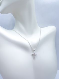 dainty CZ cross necklace on a chain White Cross Pendant Necklace With Clavicle Chain, Elegant Cross Necklace With Adjustable Chain, White Cross Necklace With Clavicle Chain, Sterling Silver Necklace With Delicate Cross Pendant, Dainty Crucifix Necklace With Adjustable Chain, Elegant Cross Charm Necklace With Adjustable Chain, Sterling Silver Crucifix Cross Necklace With Adjustable Chain, Dainty Crucifix Clavicle Chain Necklaces, Dainty Silver Crucifix Necklace