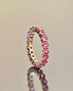 DeKara Designs Custom Metal- 18K Yellow Gold, .750. Stones- 18 Plus Round Pink Sapphires, 3.0 MM. 3.00-Carats. Number of sapphires and carat weight depends on your finger size. Size- 4-12. Please allow 3-5 working days for me to complete and ship out your eternity band. Band will be started on as soon as transaction has been processed. Handmade Beautiful Pink Sapphire Eternity Band Made in 18K Yellow Gold. There are over 18 round pink sapphires which are all prong set with perfection. The sapphi Pink Sapphire Round Eternity Band For Anniversary, Luxury Elegant Pink Sapphire Eternity Band, Pink Sapphire Eternity Band, Elegant Pink Sapphire Round Eternity Band, Elegant Pink Gemstone Eternity Band, Sapphire Eternity Band, Sapphire Wedding Band, Opal Band, Sapphire Band