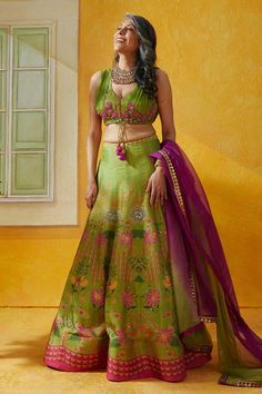 Green lehenga featuring an all-over lotus garden print with sequin and bead embellishments. Paired with a chiffon sleeveless blouse with leaf neck and an organza ombre dupatta., Fit: Relaxed Green Silk Sets For Reception, Green Silk Anarkali Set For Reception, Transitional Green Art Silk Sharara, Green Choli With Cutdana, Green Choli With Cutdana Detailing, Transitional Anarkali Green Lehenga, Green Meenakari Sharara, Green Semi-stitched Meenakari Choli, Green Silk Choli For Wedding