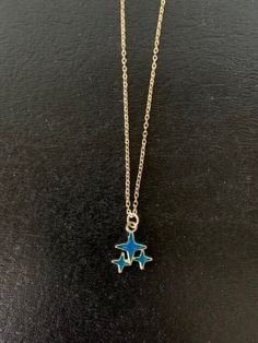 Dainty, attractive and unique gold tone and dark blue or dark turquoise blue polar stars necklace.   Pendant is small measuring 1/2" L X 1/2" W and is on an 18" chain.   ★ Want to see more?  Please visit my shop at: https://www.etsy.com/shop/DesignsByPeg Blue Star Charm Jewelry, Blue Star Shaped Necklace For Gift, Blue Star-shaped Celestial Jewelry, Celestial Blue Star-shaped Jewelry, Blue Star Charm Necklace As A Gift, Blue Star Charm Necklace As Gift, Blue Star Charm Necklace For Gift, Blue Necklace With Star Charm As A Gift, Blue Necklaces With Starfish Charm For Gifts