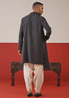 Elevate your style with Black Embroidered mirror Kurta. Made from luxurious georgette, the classic black kurta ensemble showcases intricate mirror work and stunning all-over motifs. The elegant yoke design adds a touch of sophistication. Fashioned with the embroidered dupatta and white pants. Perfect for Cocktail parties. Composition : Kurta, Patiyala & Dupatta : Viscose Georgette Care: Dry Clean Only and Vacuum Storage This product can be customized for sleeves, length and colour Delivery : 2-4 Chanderi Bandhgala With Mirror Work And Long Sleeves, Long Sleeve Chanderi Bandhgala With Mirror Work, Long Sleeve Kurta With Mirror Work For Eid, Black Chikankari Chanderi Sherwani, Black Chanderi Sherwani For Navratri, Semi-stitched Long Sleeve Bandhgala With Mirror Work, Elegant Bandhgala With Chikankari Embroidery For Navratri, Long Sleeve Chanderi Kurta With Mirror Work, Black Nehru Jacket With Zari Work