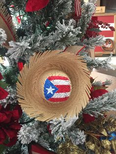 a straw hat with an american flag painted on it sits in the center of a christmas tree