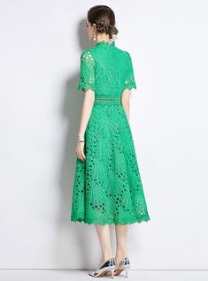 Overlaid with intricacy, this stunning green lace dress is a masterpiece of design, a garment that marries modern sophistication with timeless elegance. The high neckline and keyhole back offer glimpses of skin beneath the delicate floral lace, which runs down the length of the dress in intricate patterns. Its mid-length cut and cinched waist create a flattering silhouette, while the carefully crafted lace exudes a sense of refined grace. The cap sleeves add a touch of modesty, balanced by the d Green Lace Dress, Short Sleeve Lace Dress, Sleeve Lace Dress, Green Lace Dresses, Fashion Design Dress, Evening Jackets, Contemporary Chic, Lace Midi, Woman Standing