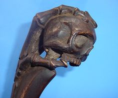 a wooden sculpture of a cat on a blue background