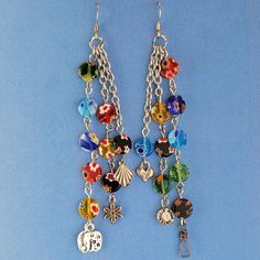 These handmade Boho earrings have African glass flower beads in a variety of colors and designs, along with an eclectic mix of pewter and antiqued silver charms. The ear wires are hypoallergenic surgical steel. Total earring length is 4.