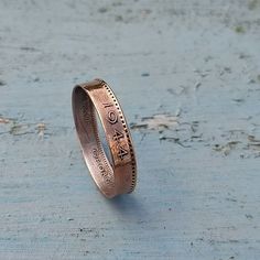 Bronze ring made from an old 'Farthing' coin, inside coated in a fine silver solution. Handmade to order from sizes K-T The farthing was a small copper coin that was used in the United Kingdom from 1860 to 1960. It was worth one-quarter of a penny and was the smallest denomination coin in circulation.  Shipped with untracked 2nd Class royal Mail All coins are coated with a silver solution on the inside to reduce tarnishing however, Copper can leave a green residue when it oxidizes, according to Newton Ask a Scientist. Chemicals in soaps, lotions, and other skincare products, along with the natural acids released as we sweat, can cause copper jewellery to oxidize and leave green marks on our skin. Green or black discoloration on your skin caused by oxidization can be removed with soap and w Vintage Silver-colored Copper Rings, Vintage Silver Copper Rings, Copper Coin, Copper Jewellery, Copper Coins, Bronze Ring, Coin Ring, A Penny, Clear Nails