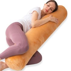 a woman laying on a large inflatable pillow with her arms resting on it