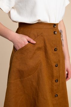 Part of our Rome Collection, the Fiore Skirt is a chic, high-waisted A-line skirt with just the right amount of flare and volume. A beginner-friendly pattern with multiple variations, this elevated basic has tons of outfit potential. Available in above or below the knee lengths, the Fiore Skirt has three views. View A is a simple flared skirt with an invisible zipper at the back. View B is an asymmetrical wrap skirt with a single hip pocket. View C buttons up the front with curved patch pockets. Casual Party Clothes, A Line Skirt Pattern, Closet Core Patterns, Skirt Sewing, Basic Skirt, Garment Pattern, Skirt Patterns Sewing, Sewing Skirts, Woman Dress